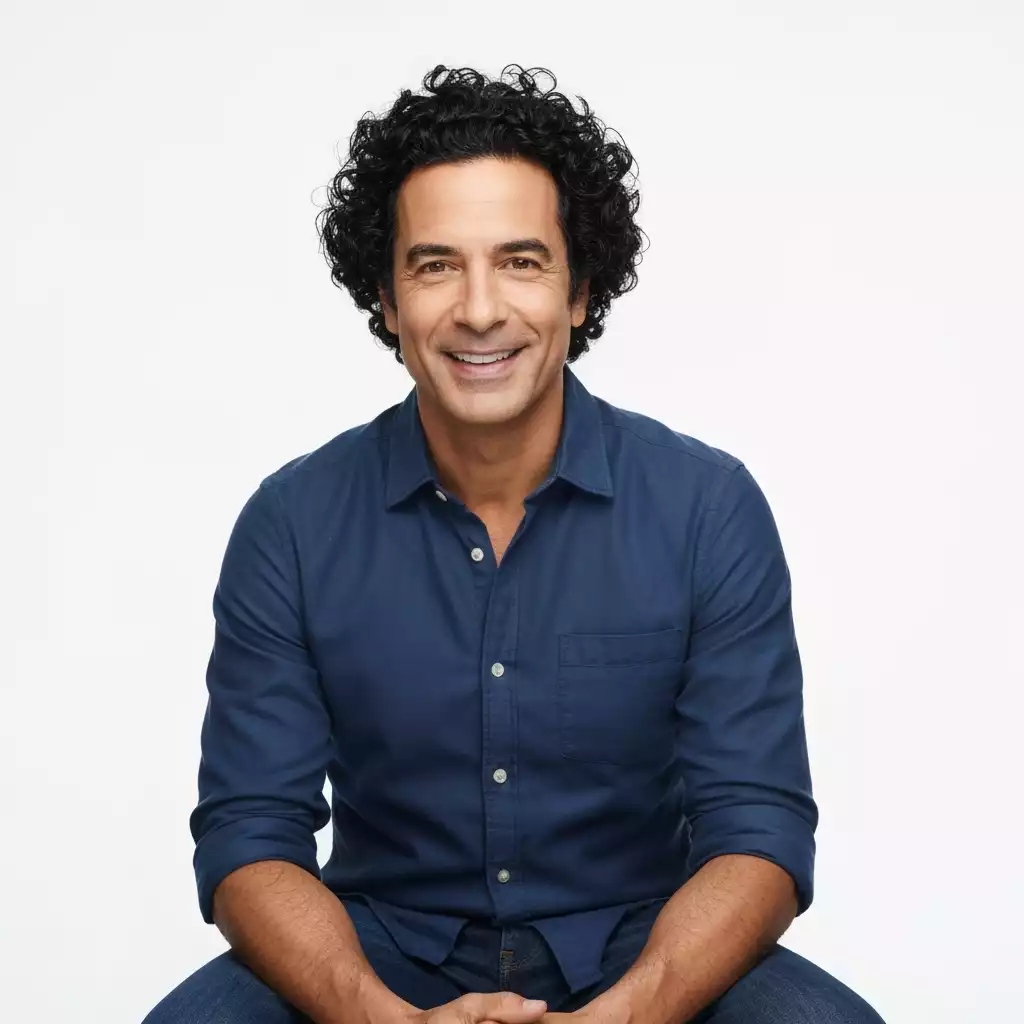 Person with defined curly hair looking happy